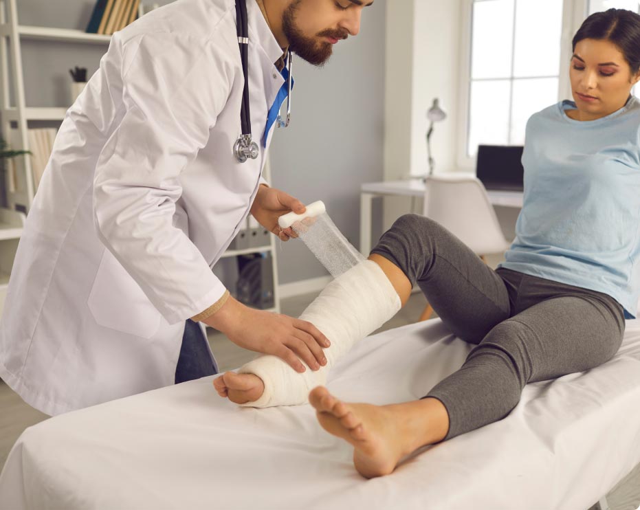 doctor wrapping a cast on a patient